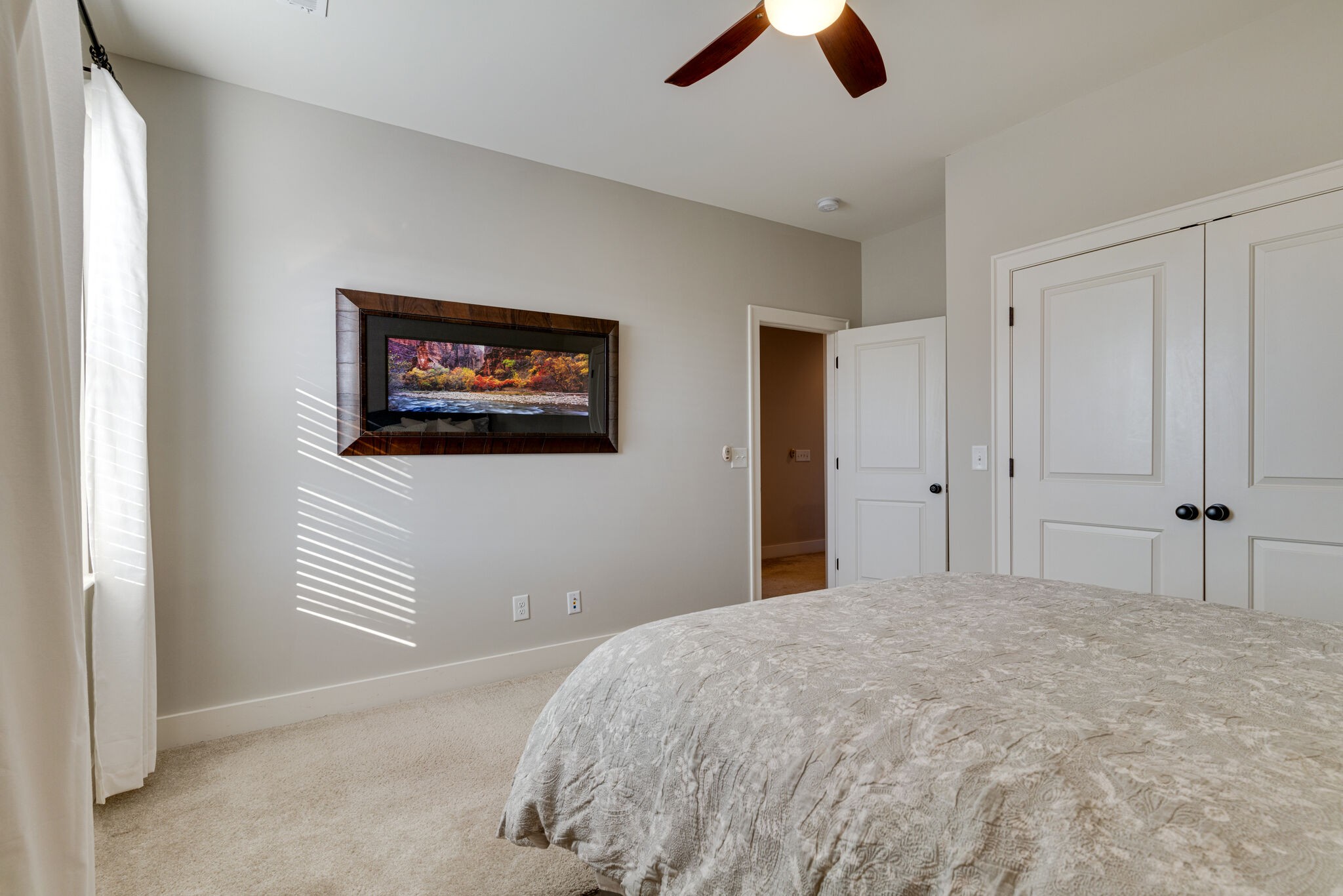 136 Vanner Road Mount Juliet, TN 37122 - Photo 26 of 55 a bedroom with a large bed and a chandelier