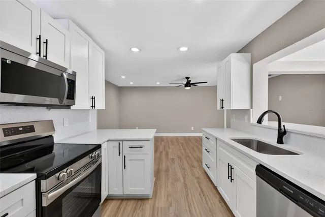 a living room with hardwood floor and large window