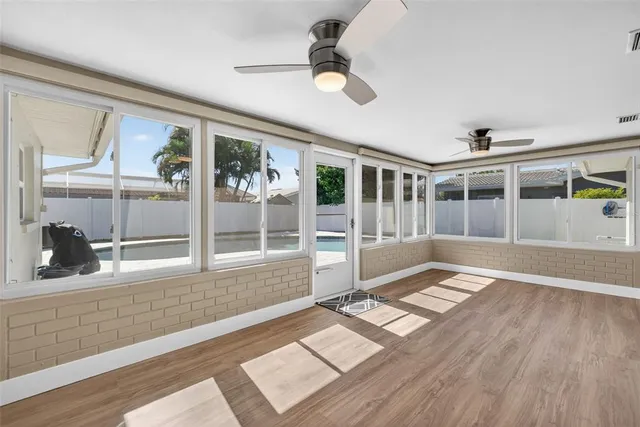 a spacious bedroom with a bed and a potted plant