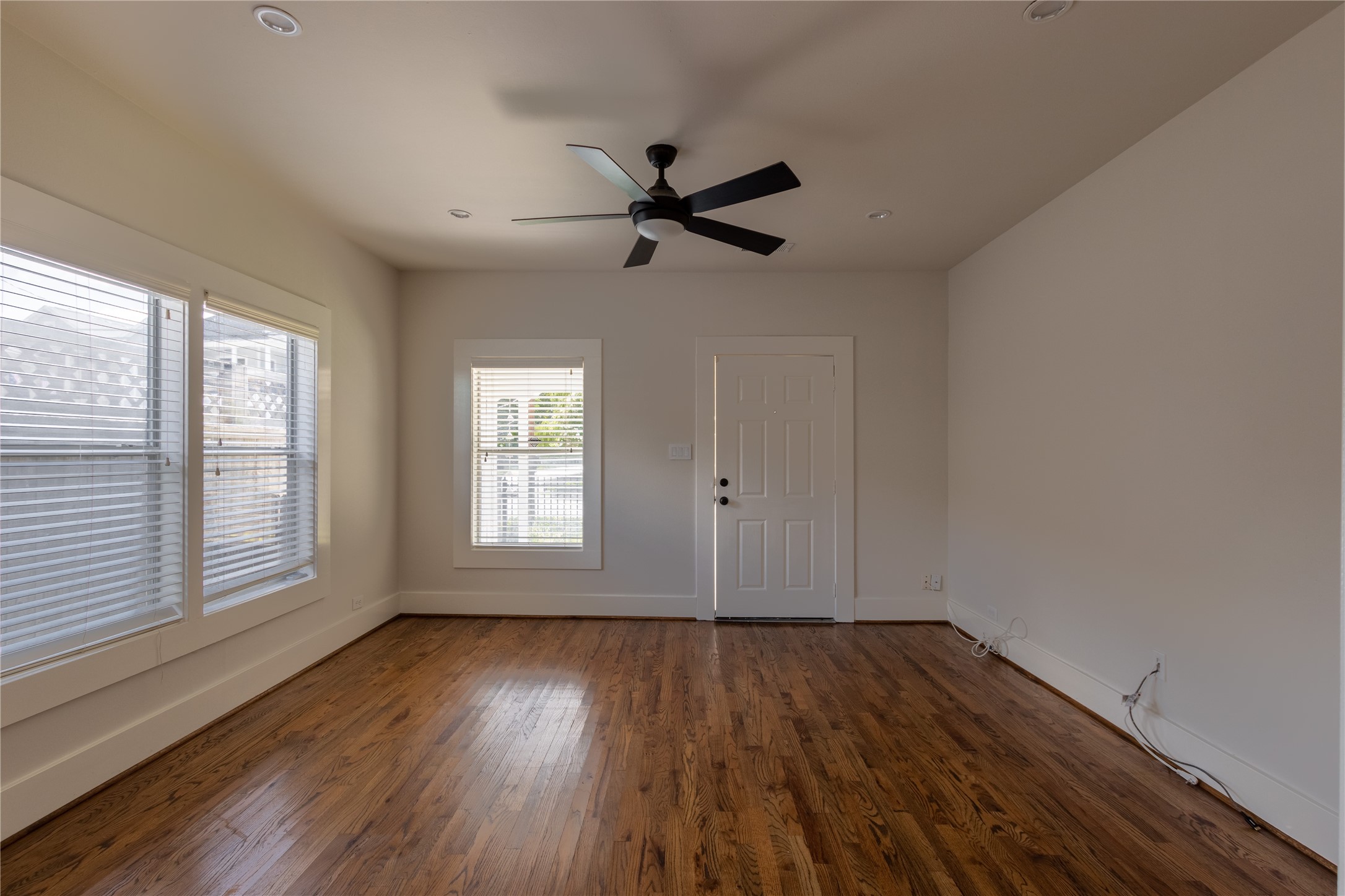 2009 Singleton Street Houston, TX 77008 - Photo 9 of 24 an empty room with wooden floor a ceiling fan and windows