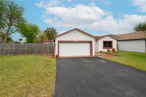 a view of a house with a yard and garage