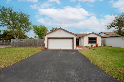 a view of a house with a yard and garage