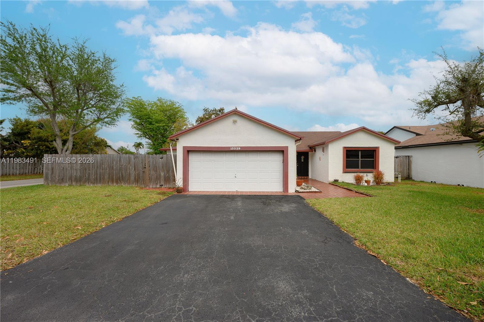 13329 Southwest 113th Place Miami, FL 33176 - Photo 2 of 43 a view of a house with a yard and garage