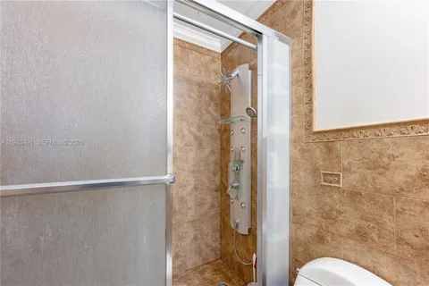 a bathroom with a shower and toilet