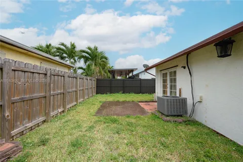 a backyard of a house with wooden fence