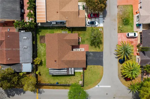 an aerial view of a house with yard swimming pool and outdoor seating