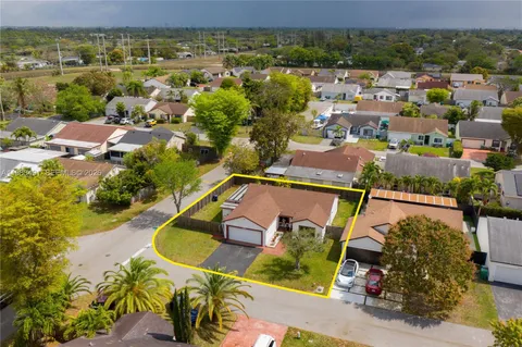 an aerial view of residential houses with outdoor space and swimming pool