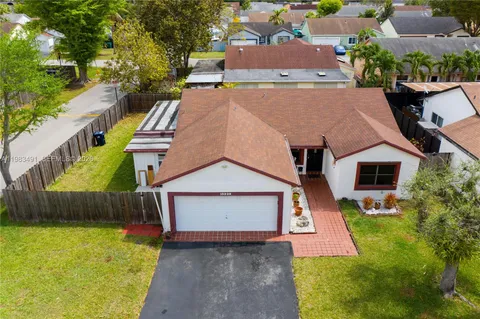 an aerial view of a house with a yard