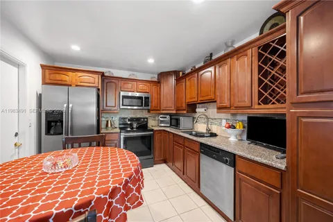 a kitchen with stainless steel appliances granite countertop a refrigerator sink and cabinets