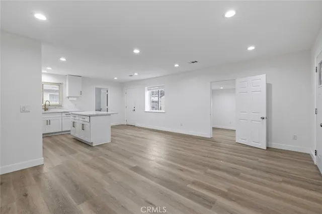 a view of kitchen with wooden floor and windows