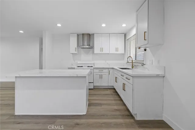 a kitchen with white cabinets and white appliances