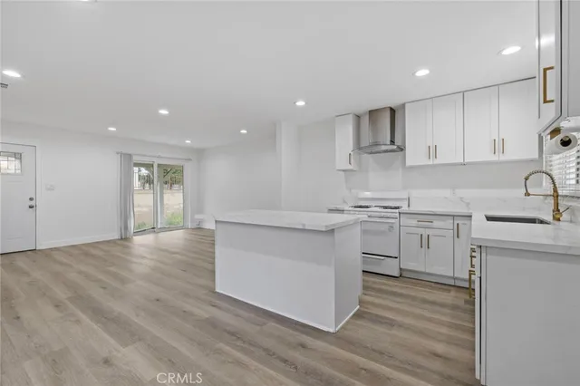 a kitchen with white cabinets stainless steel appliances and sink