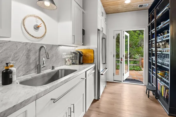 a kitchen with a refrigerator and a sink