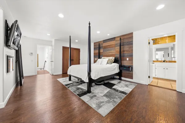 a living room with furniture rug and wooden floor