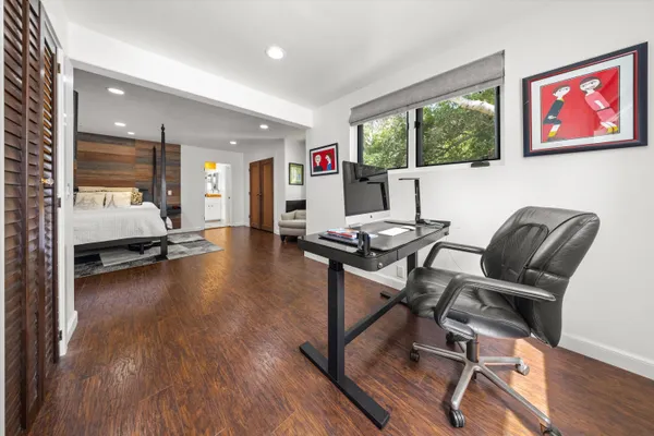 a living room with furniture and a wooden floor
