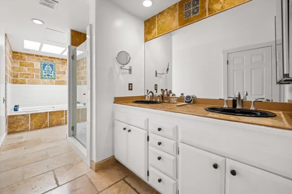 a bathroom with a sink double vanity and a mirror