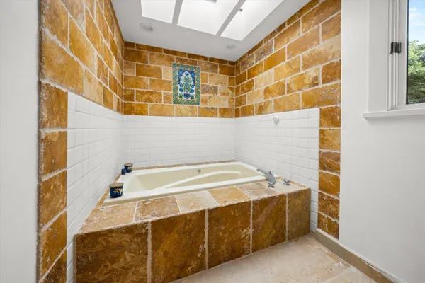 a bathroom with a tub and a sink