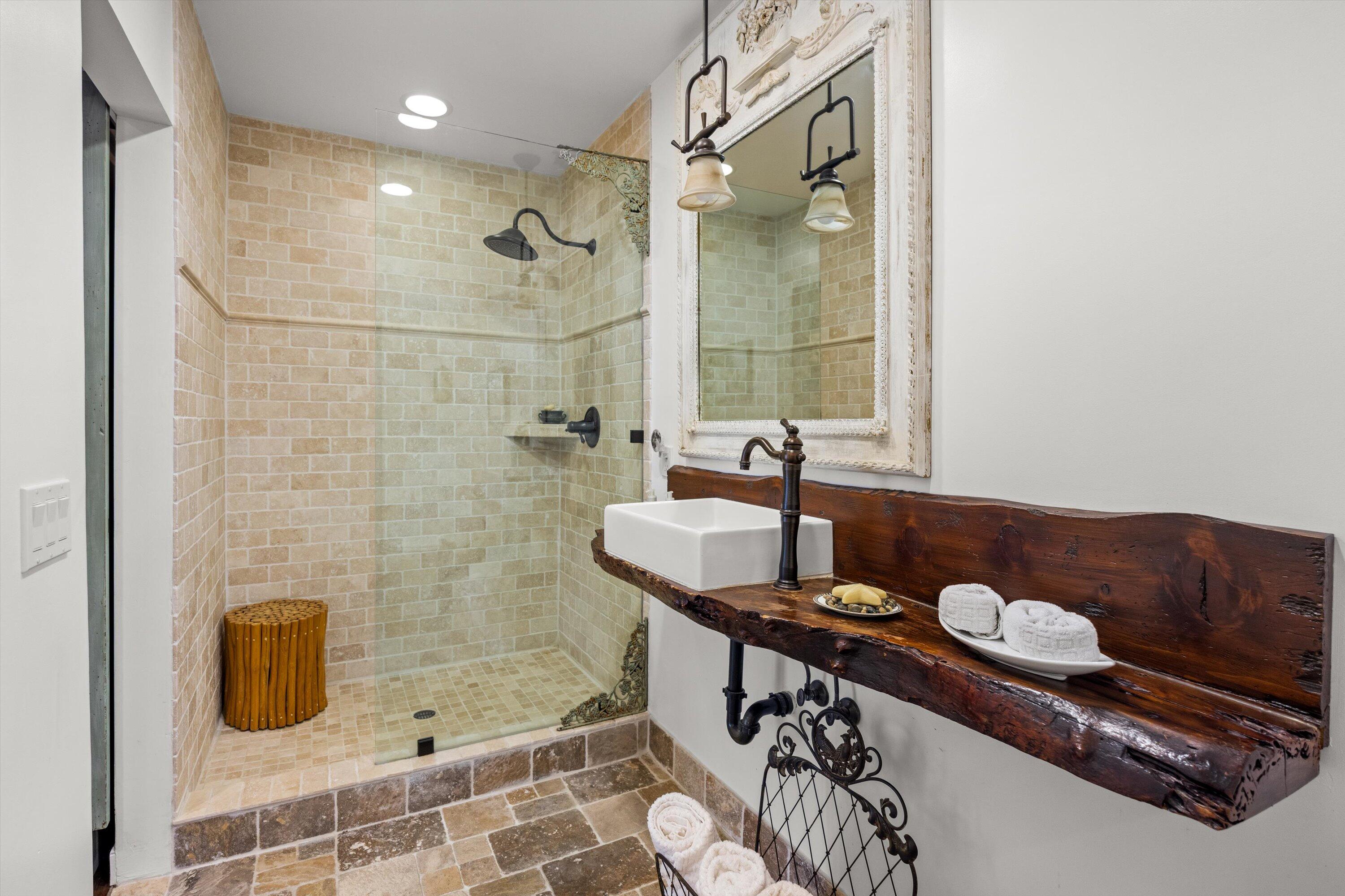 1435 Sycamore Canyon Road Santa Barbara, CA 93108 - Photo 24 of 49 a bathroom with a tub shower and a sink