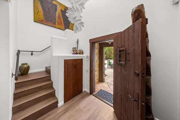 a view of entryway and hall with wooden floor