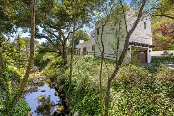 a backyard of a house with table and chairs