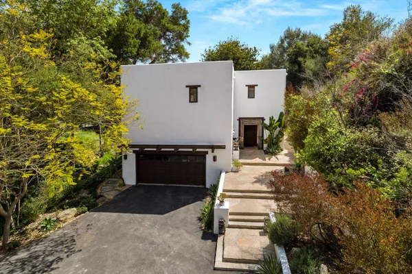 aerial view of a house with balcony and garden