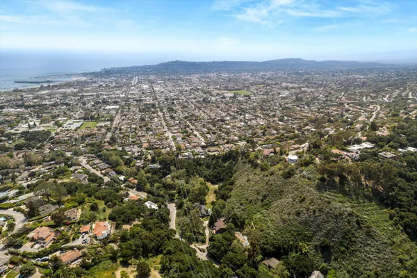 an aerial view of residential houses with city view