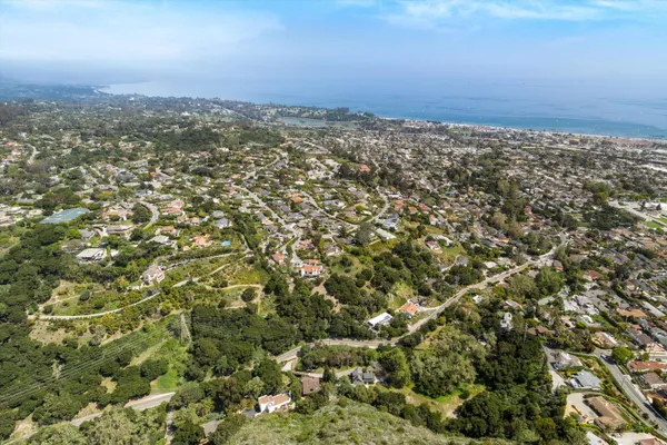 an aerial view of residential houses with city view