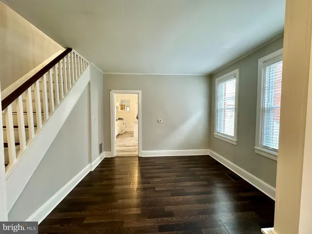 a view of an entryway with wooden floor and stairs