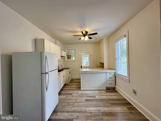 a view of a kitchen with a refrigerator and a window
