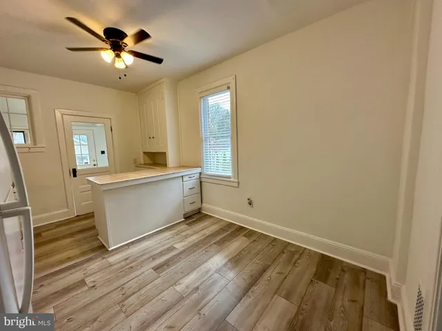 a view of a room with a sink and a mirror