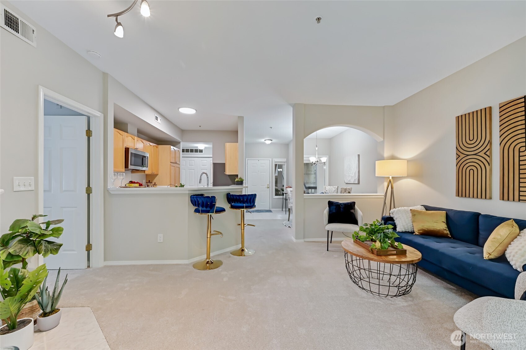 12109 Northeast 171st Place, Unit B103 Bothell, WA 98011 - Photo 11 of 39 a living room with furniture and a chandelier
