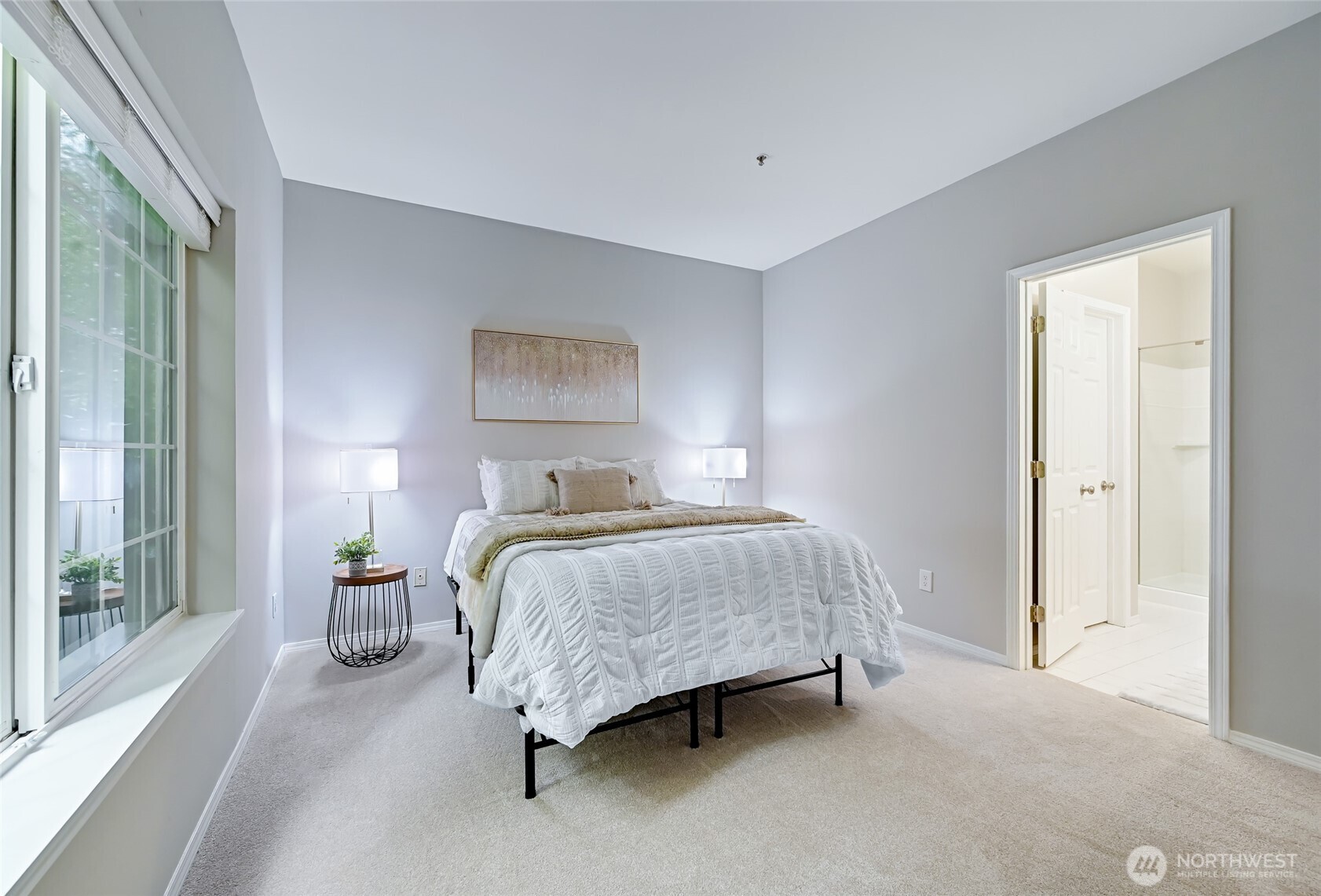 12109 Northeast 171st Place, Unit B103 Bothell, WA 98011 - Photo 12 of 39 a bedroom with a bed and large windows