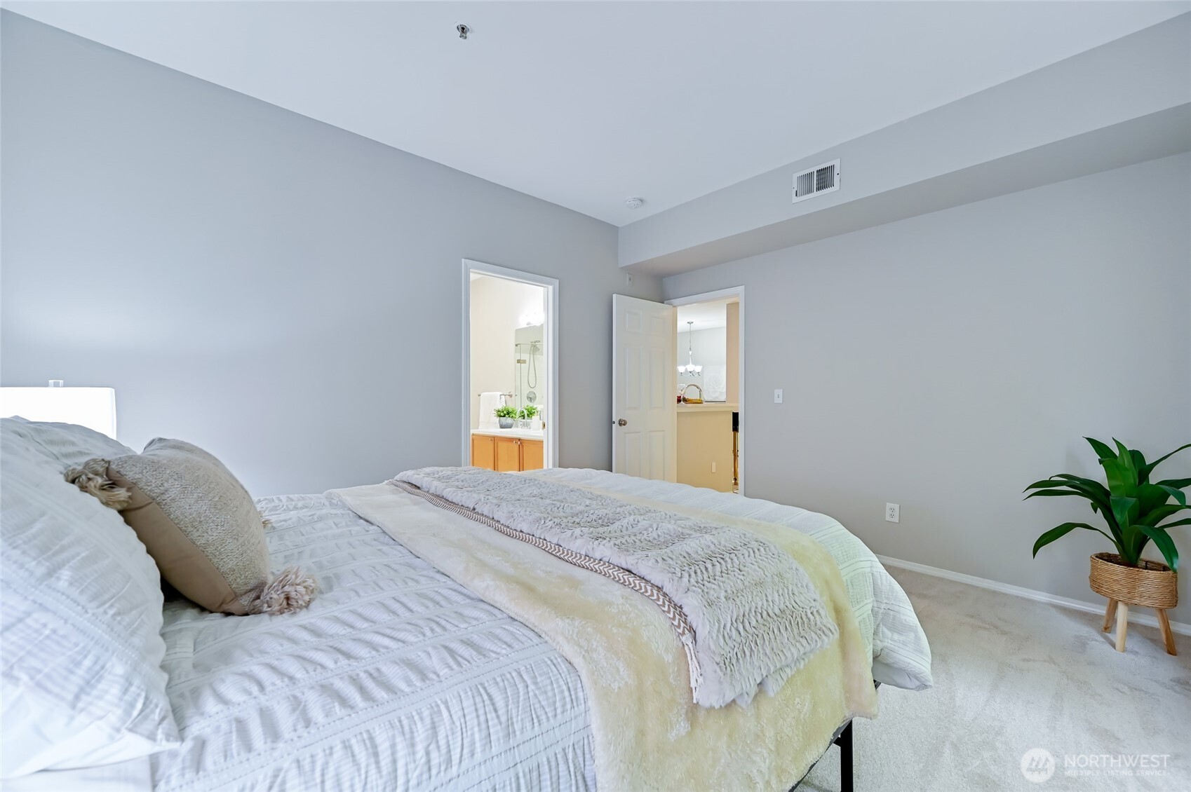 12109 Northeast 171st Place, Unit B103 Bothell, WA 98011 - Photo 13 of 39 a bedroom with a bed and potted plant
