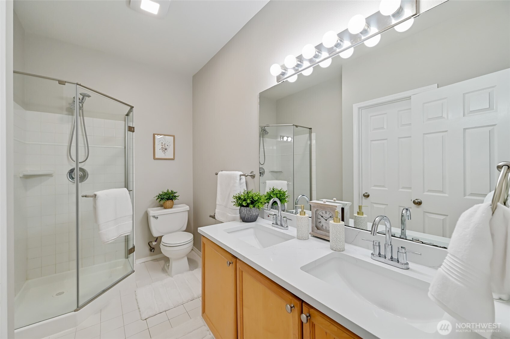 12109 Northeast 171st Place, Unit B103 Bothell, WA 98011 - Photo 14 of 39 a bathroom with a sink double vanity and a mirror