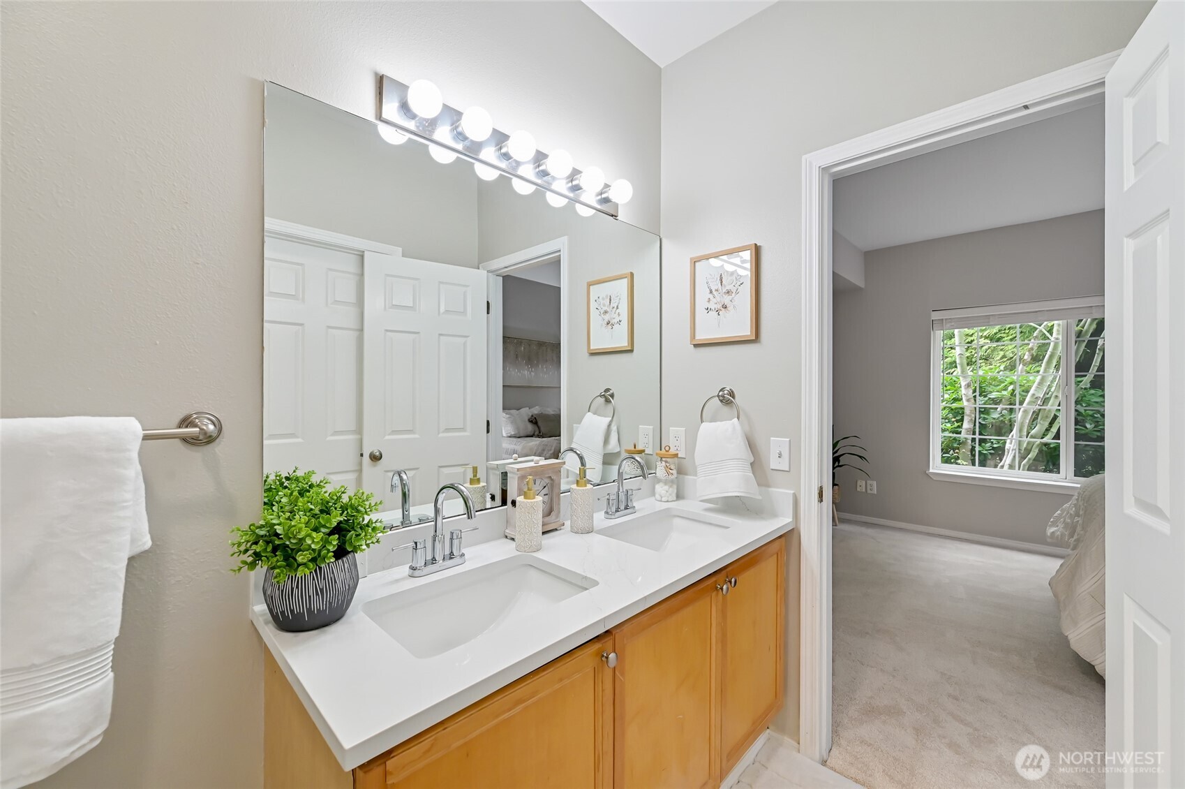 12109 Northeast 171st Place, Unit B103 Bothell, WA 98011 - Photo 16 of 39 a bathroom with a double vanity sink and a mirror
