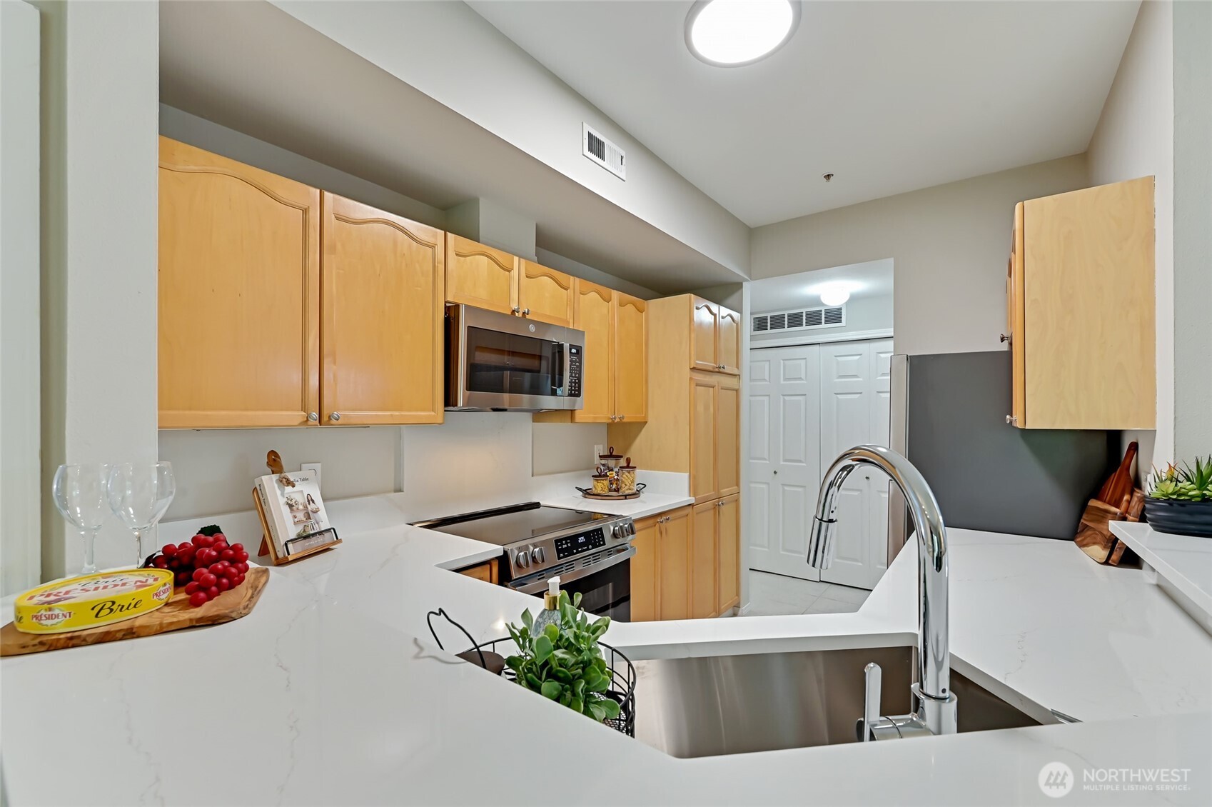 12109 Northeast 171st Place, Unit B103 Bothell, WA 98011 - Photo 17 of 39 a kitchen that has a sink and a stove