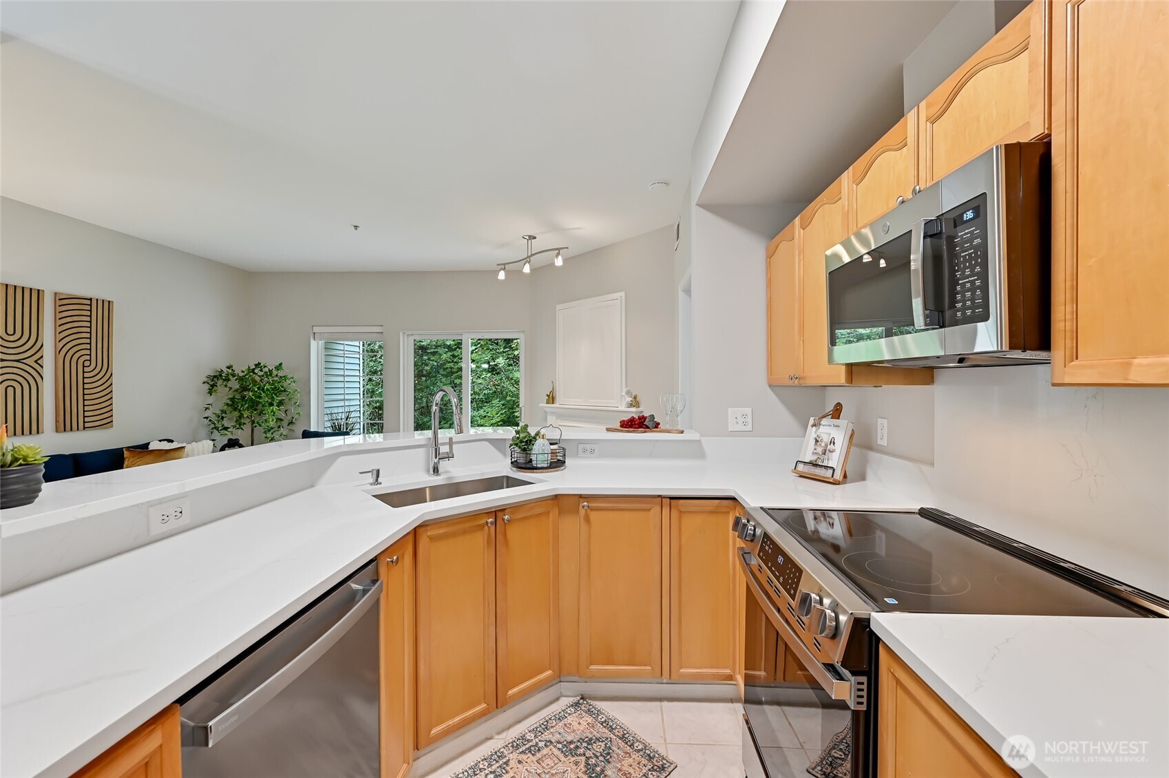 12109 Northeast 171st Place, Unit B103 Bothell, WA 98011 - Photo 18 of 39 a kitchen with a sink a stove and cabinets