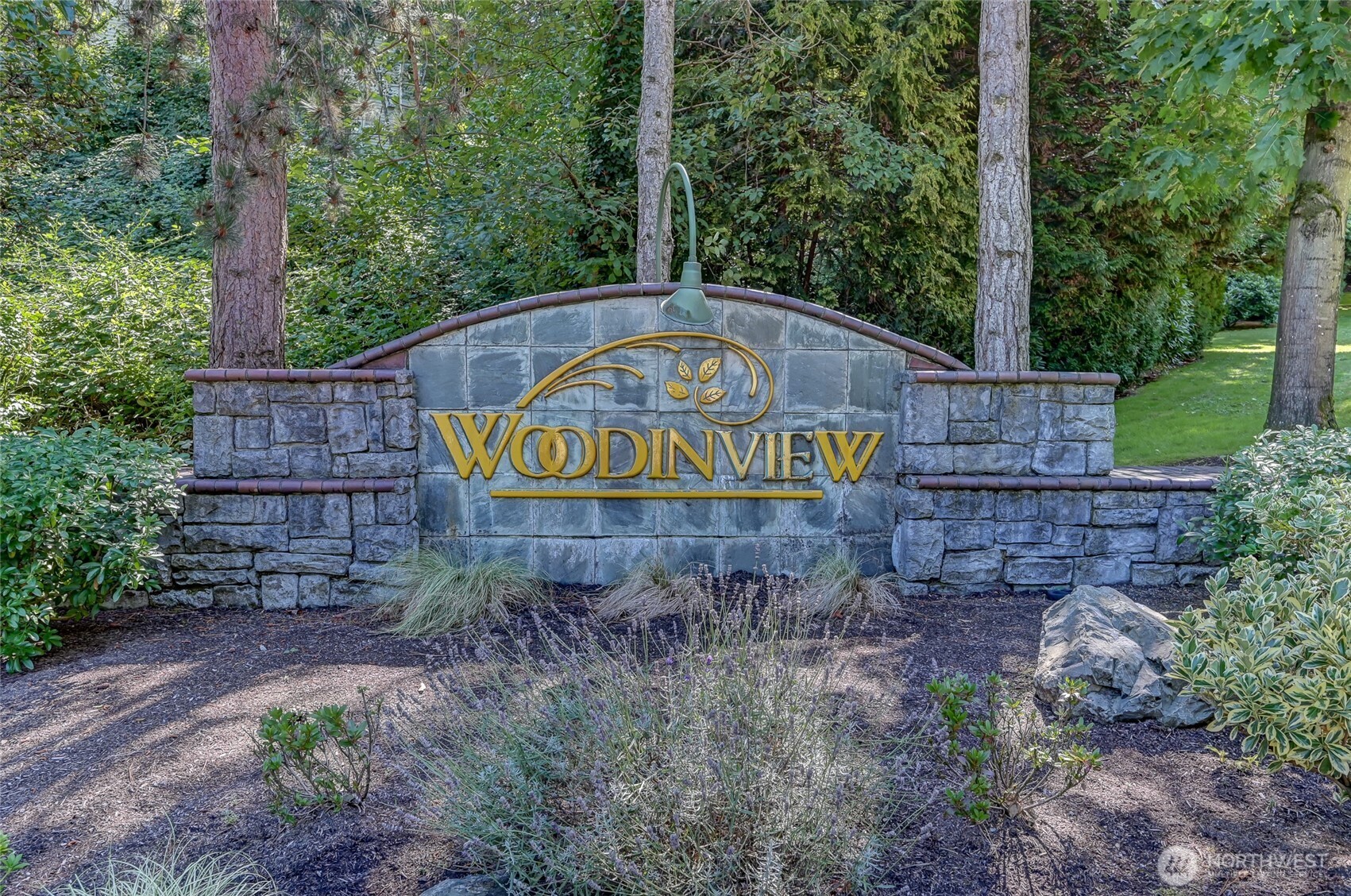 12109 Northeast 171st Place, Unit B103 Bothell, WA 98011 - Photo 38 of 39 a view of a sign board with large trees