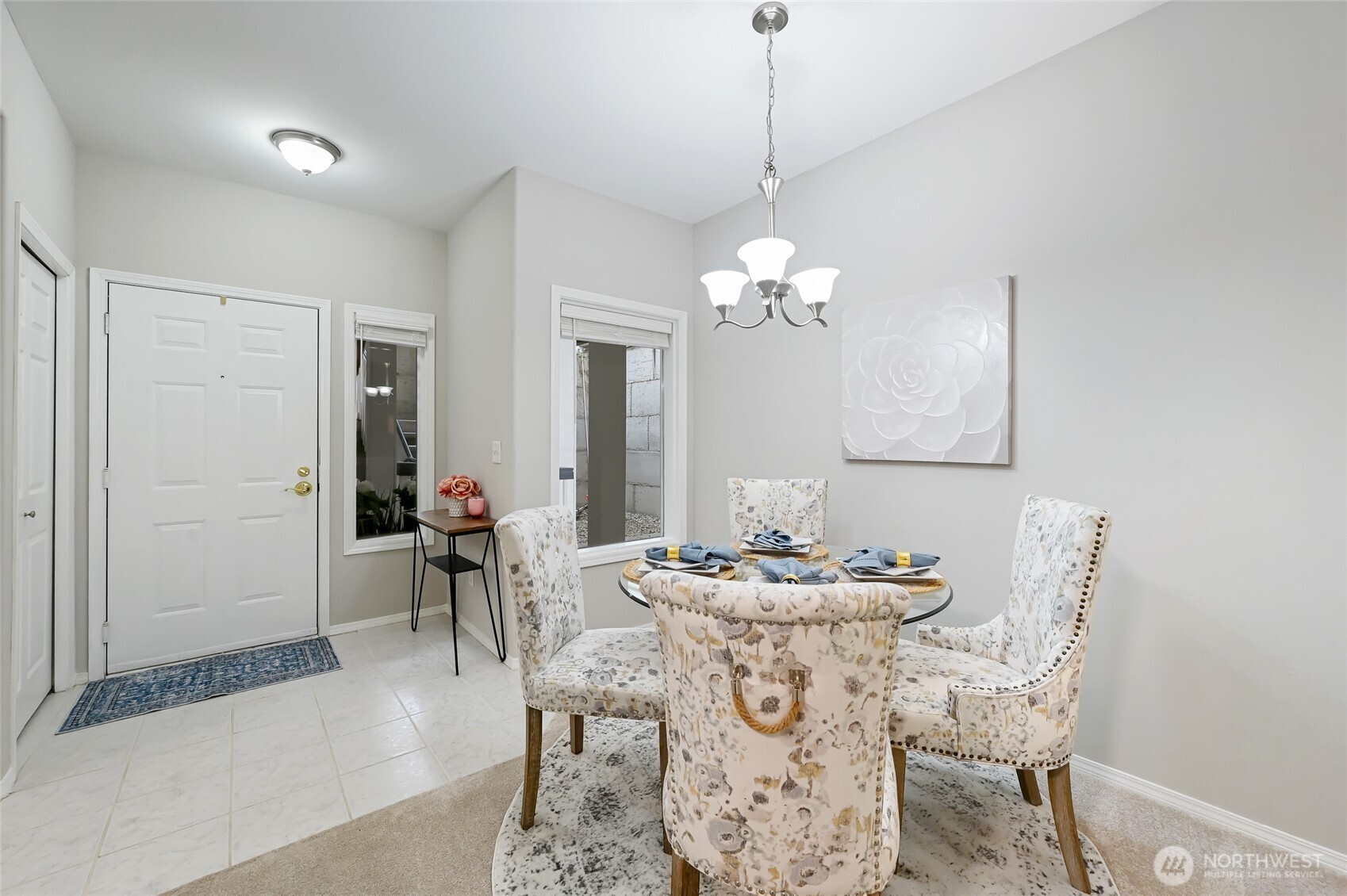 12109 Northeast 171st Place, Unit B103 Bothell, WA 98011 - Photo 7 of 39 a dining room with furniture a chandelier and window