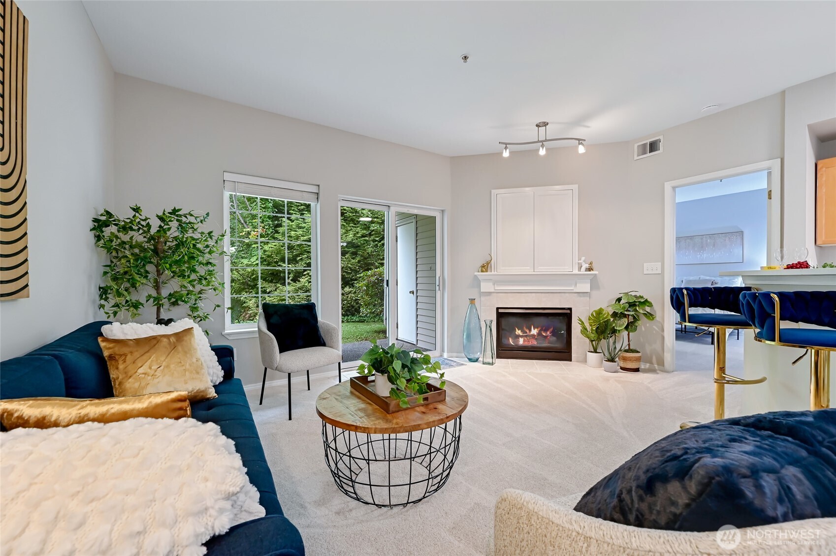 12109 Northeast 171st Place, Unit B103 Bothell, WA 98011 - Photo 10 of 39 a living room with furniture a fireplace and potted plants