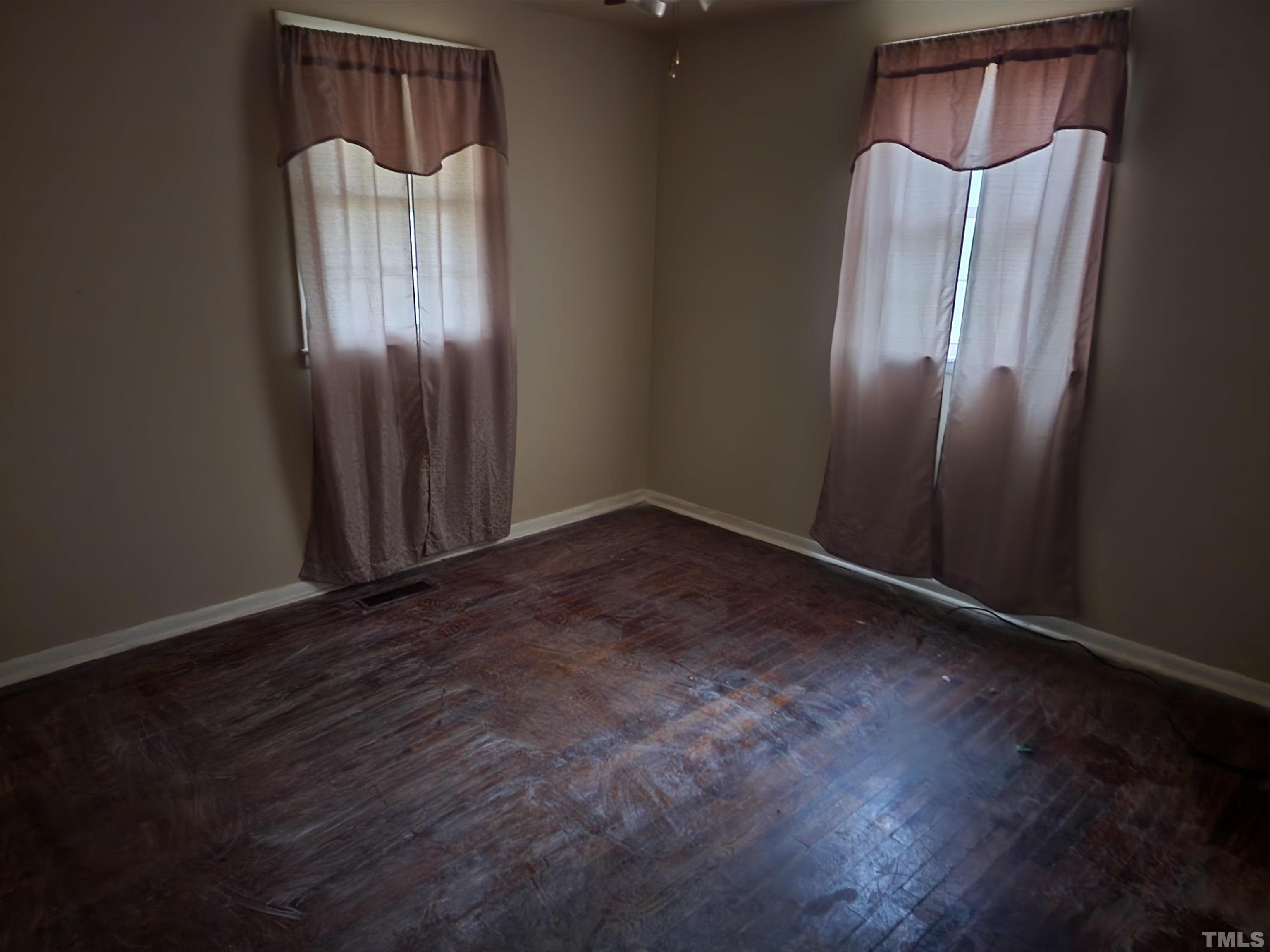 808 Newcombe Road Raleigh, NC 27610 - Photo 2 of 4 an empty room with wooden floor and front door