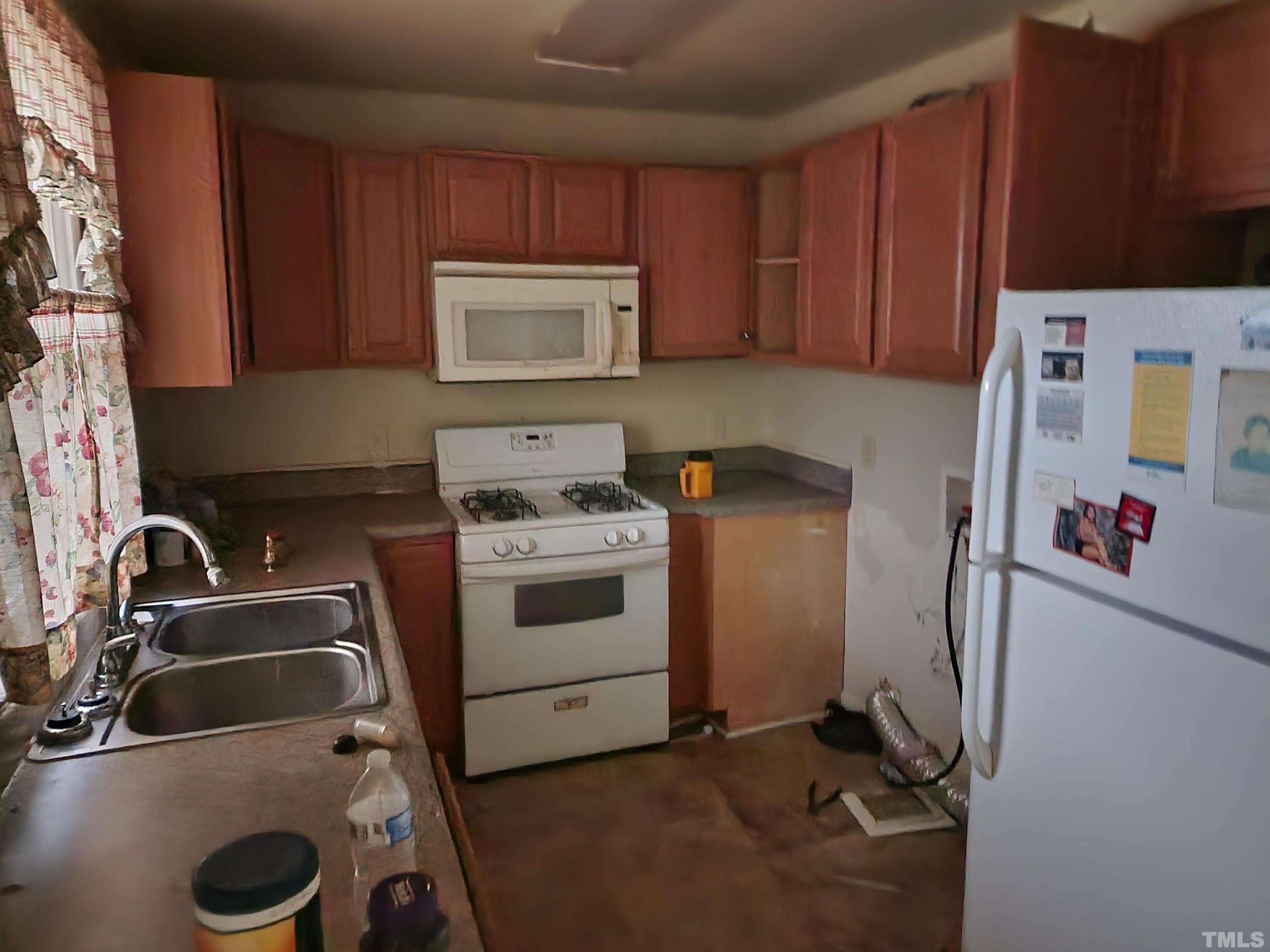808 Newcombe Road Raleigh, NC 27610 - Photo 3 of 4 a view of a kitchen with sink dryer and washer