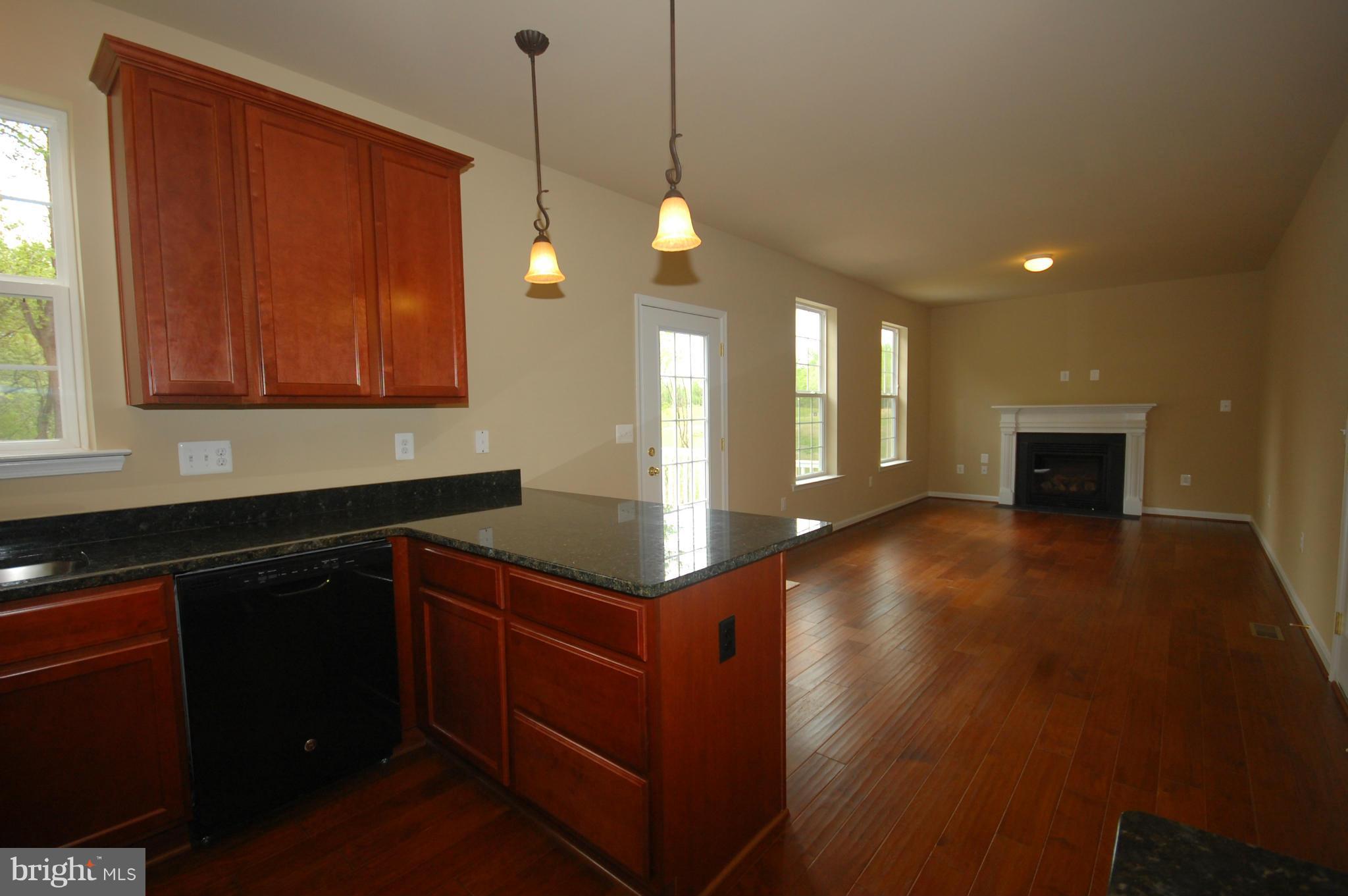 116 MacKenzie Court Huntingtown, MD 20639 - Photo 14 of 28 a kitchen with stainless steel appliances granite countertop a stove a sink and a wooden floors