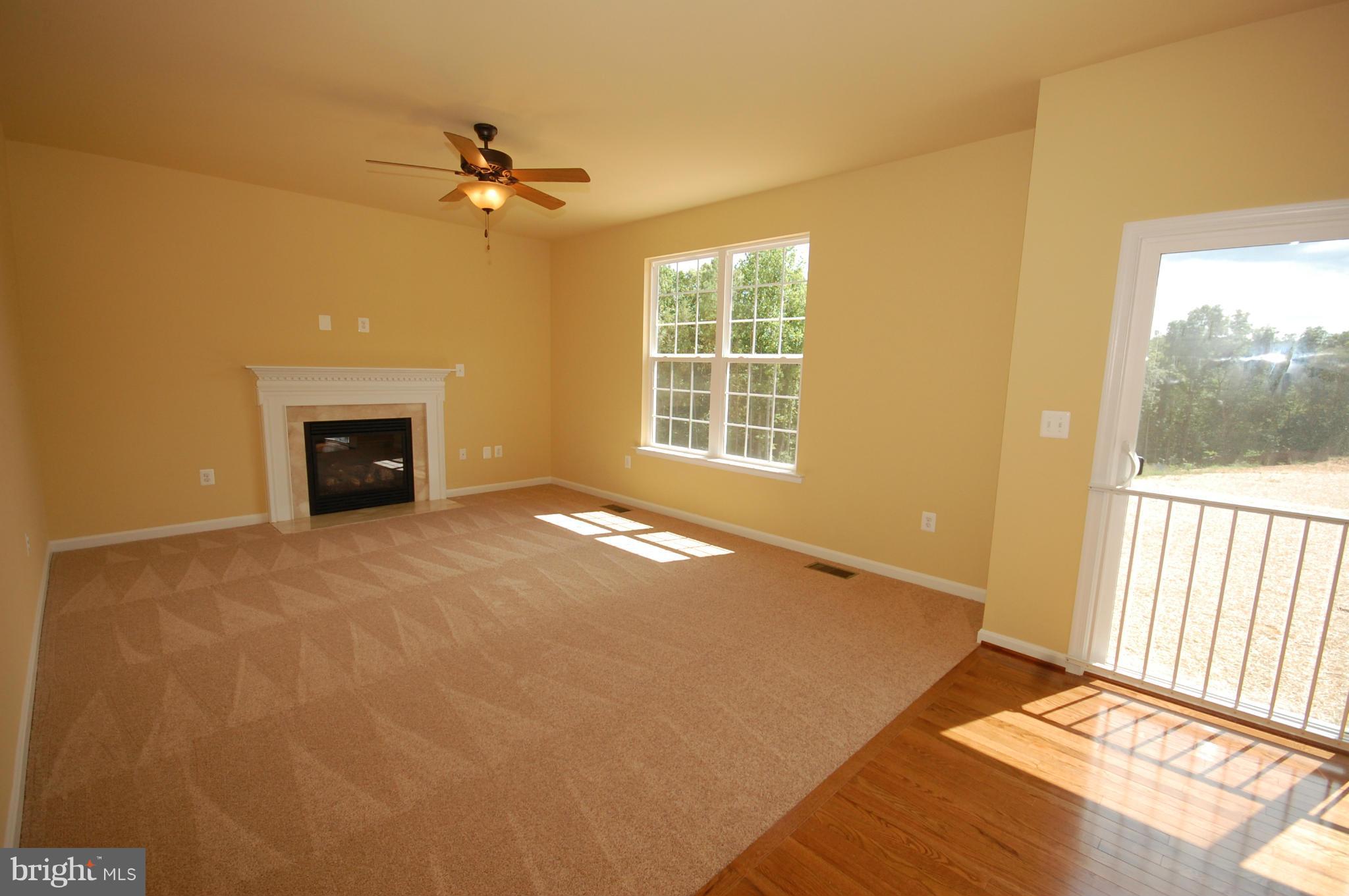 116 MacKenzie Court Huntingtown, MD 20639 - Photo 22 of 28 a view of an empty room with a window and a kitchen