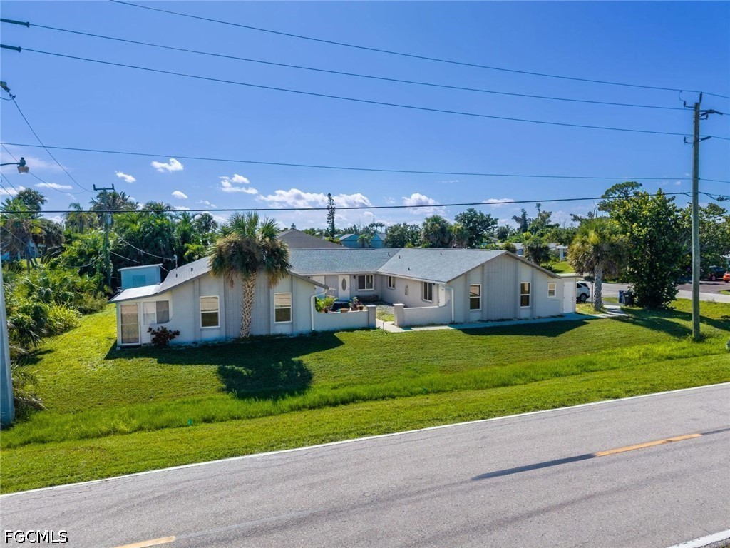 16595 Davis Road Fort Myers, FL 33908 - Photo 1 of 31 a front view of a house with garden