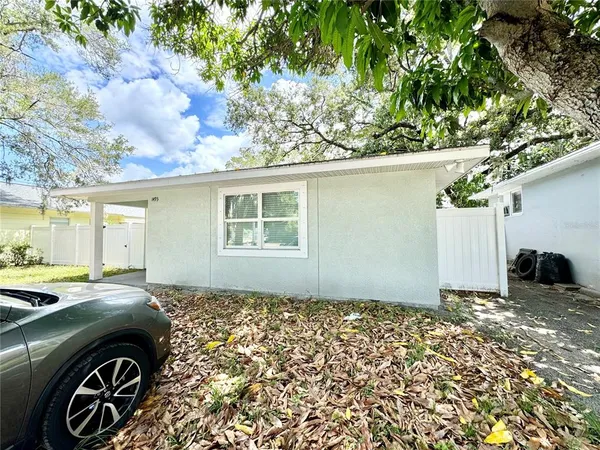 a kitchen with a refrigerator a microwave a sink and cabinets