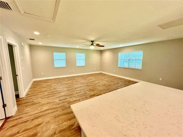 an aerial view of a house with a yard and lake view