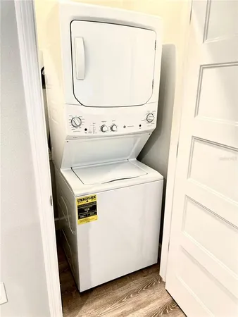 an aerial view of residential houses with outdoor space and lake view
