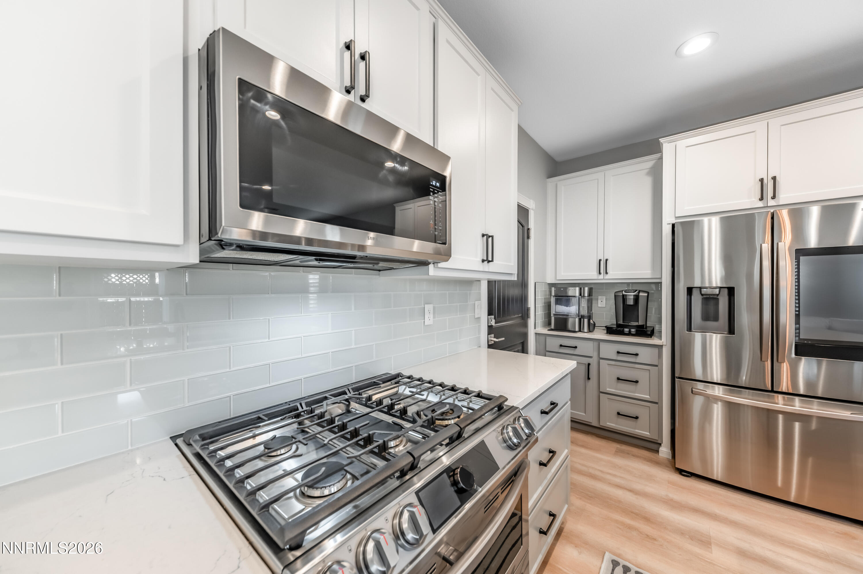 9530 Vikingholm Road Reno, NV 89521 - Photo 11 of 42 a kitchen with stainless steel appliances a sink a stove a microwave and cabinets