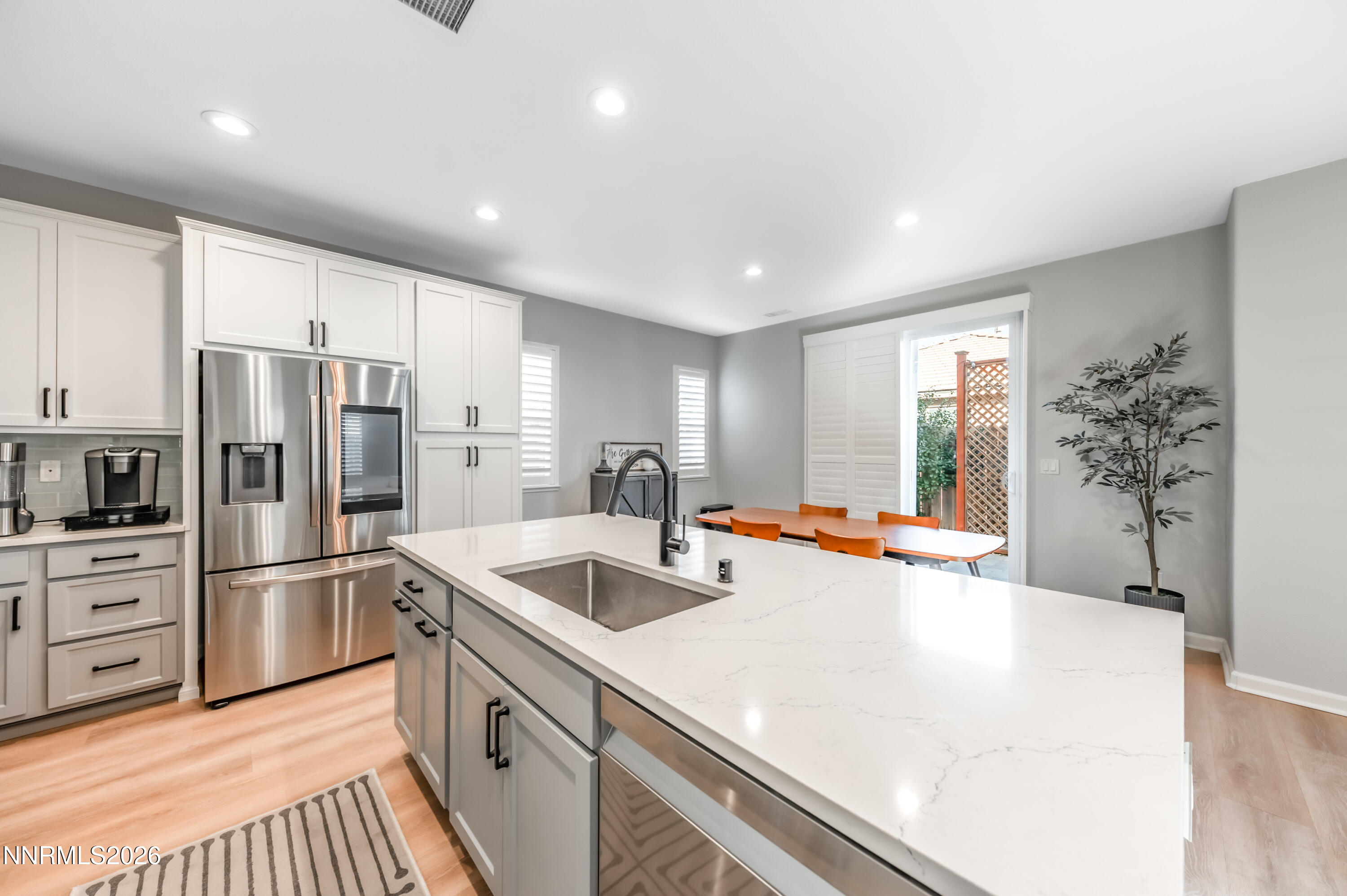9530 Vikingholm Road Reno, NV 89521 - Photo 12 of 42 a kitchen with refrigerator a stove and cabinets